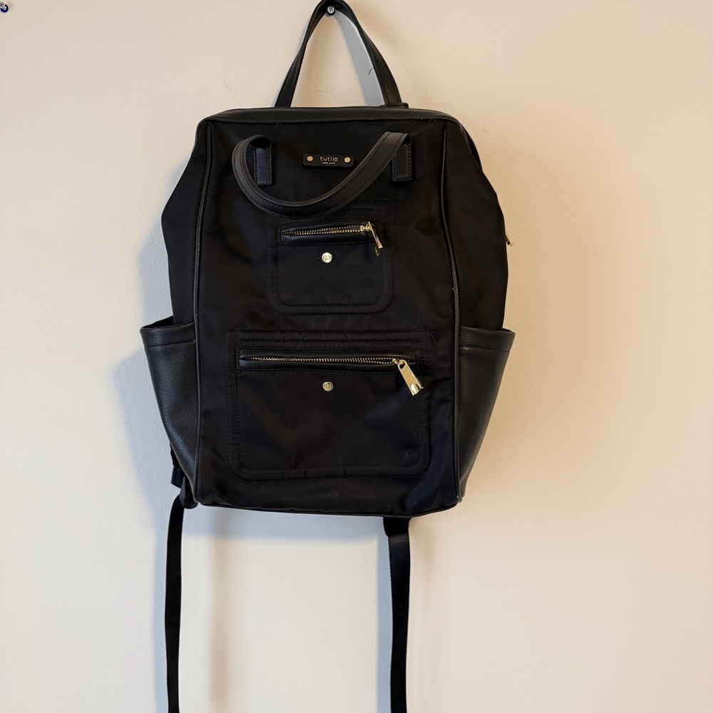 Black Backpack with Clamshell zip opening.